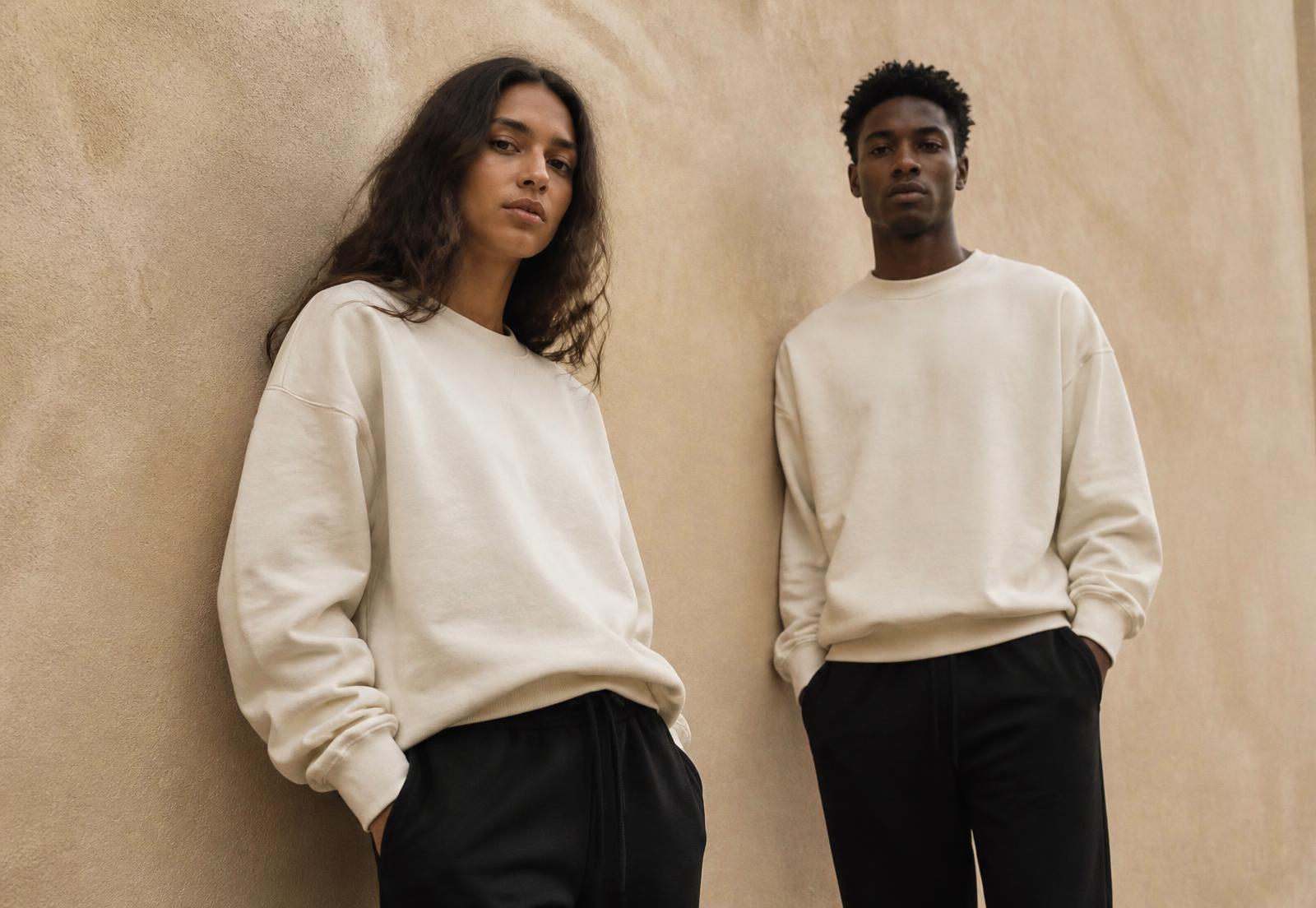 Two models wearing Mae&Co cream sweatshirts and black joggers